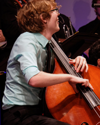 sdsu jazz student playing stand-up bass on stage